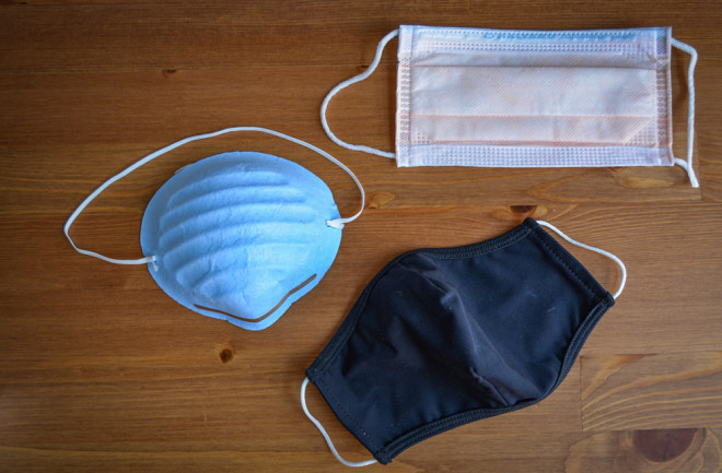 Face mask options on a table covid-19 pandemic coronavirus - shutterstock